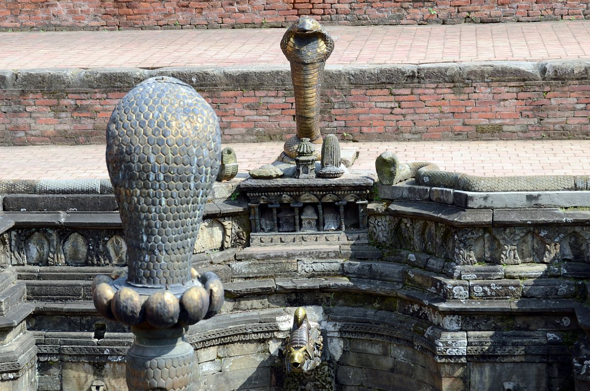 Kathmandu Bhaktapur 05-3 Bhaktapur Durbar Square Naga Pokhari Cobra Heads Close Up Naga cobra heads face each other in the Naga Pokhari in the Palace of 55 Windows in Bhaktapurs Durbar Square.